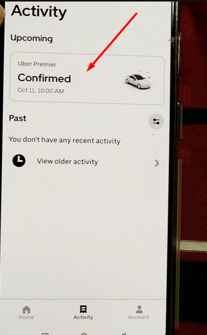pointing towards Confirmed button above date and time of the reserved ride